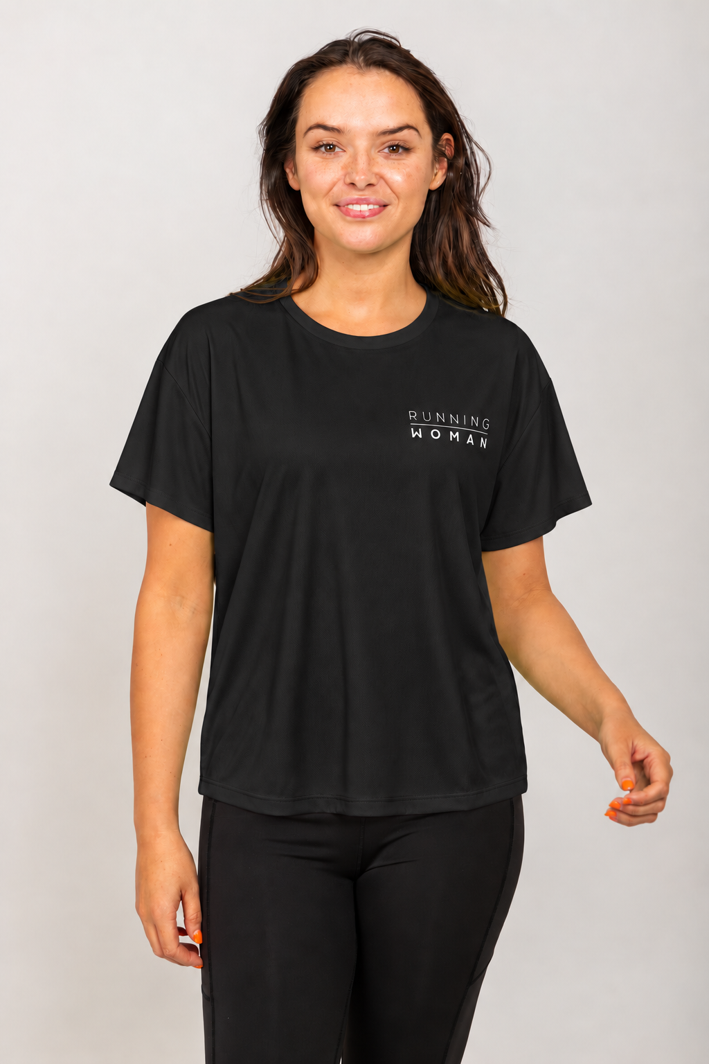 Black open-back Running Woman T-shirt on a brunette model facing forward in a relaxed pose