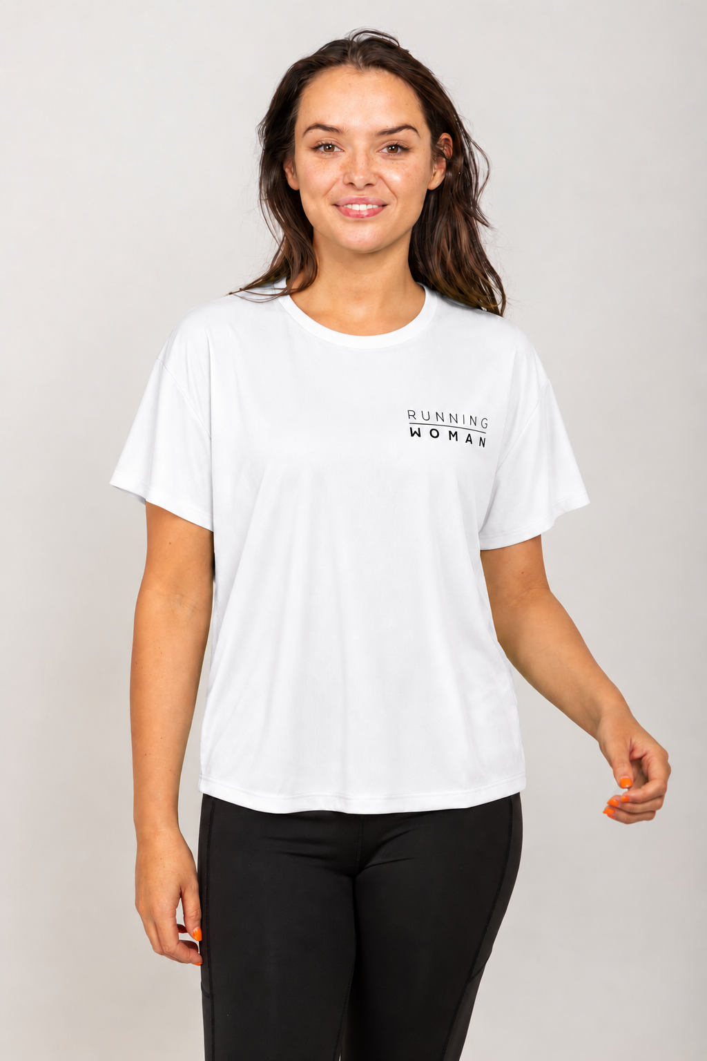 White open-back Running Woman T-shirt on a brunette model facing forward in a relaxed pose