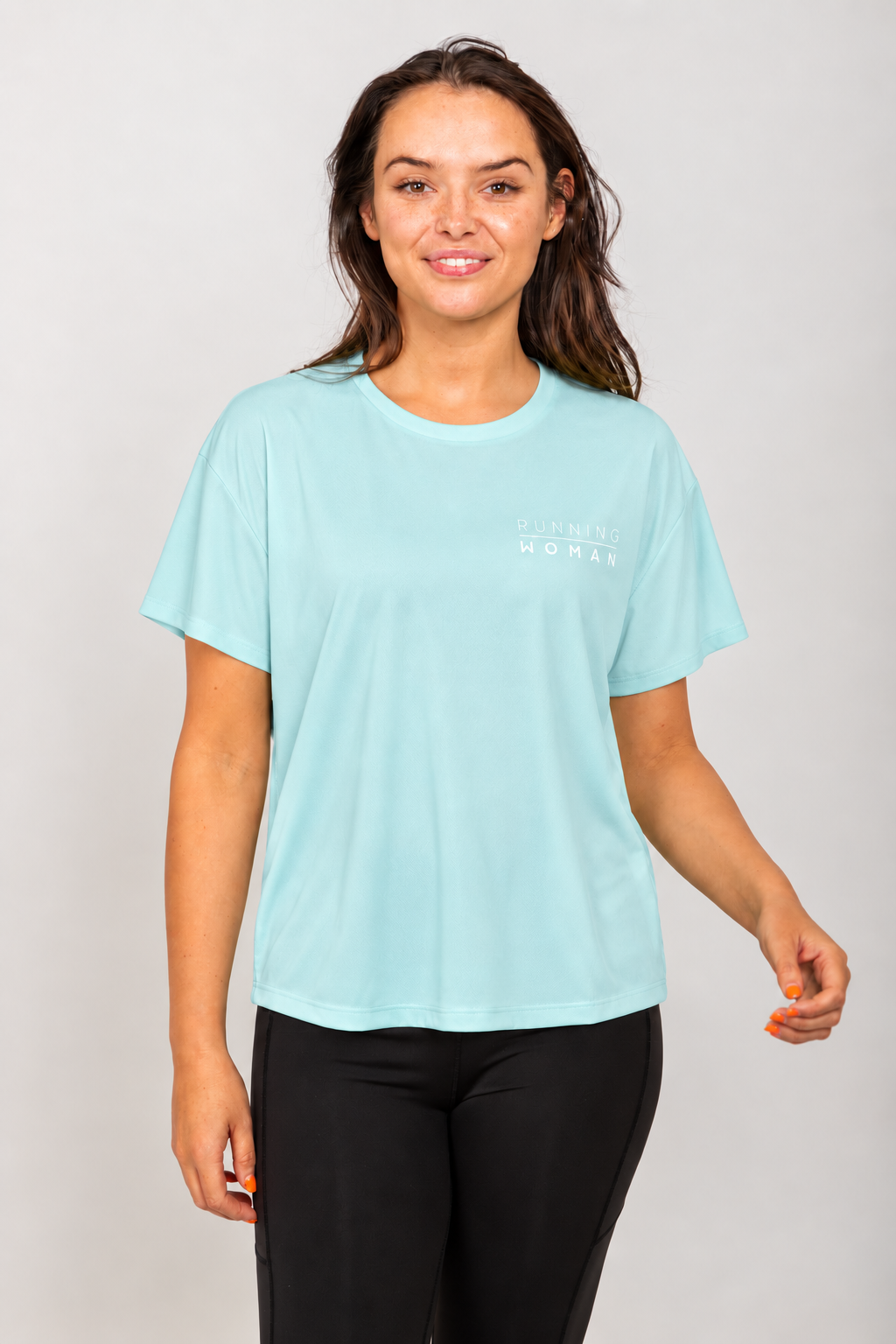 Mint open-back Running Woman T-shirt on a brunette model facing forward in a relaxed pose