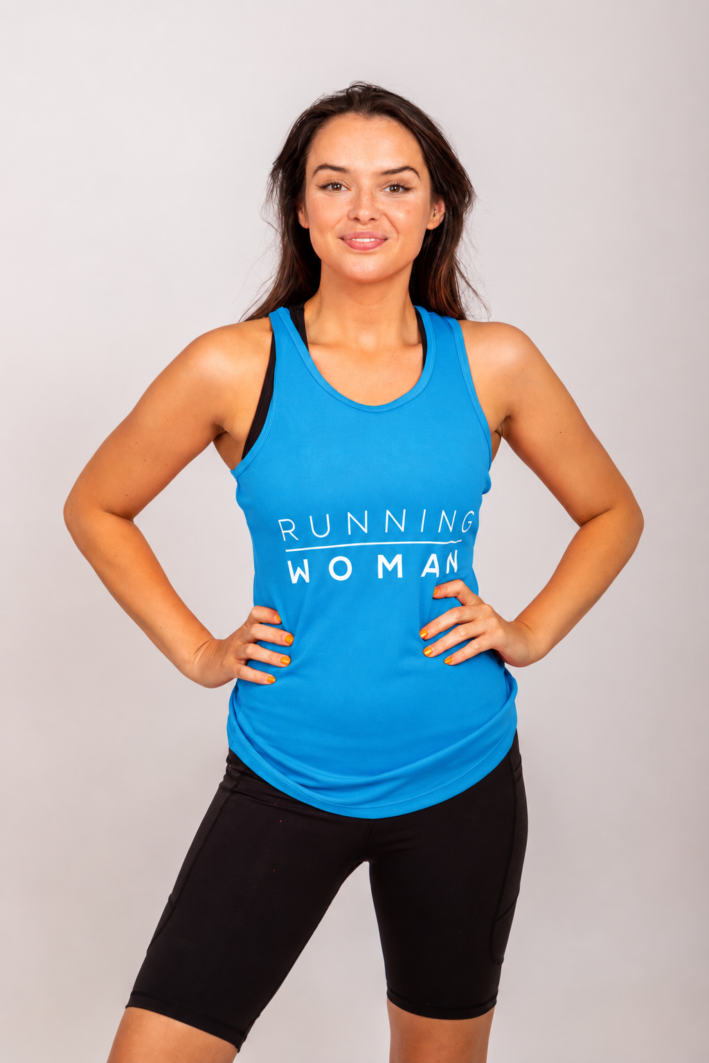 Sapphire blue Running Woman running vest on a model facing forward with both hands on her hips