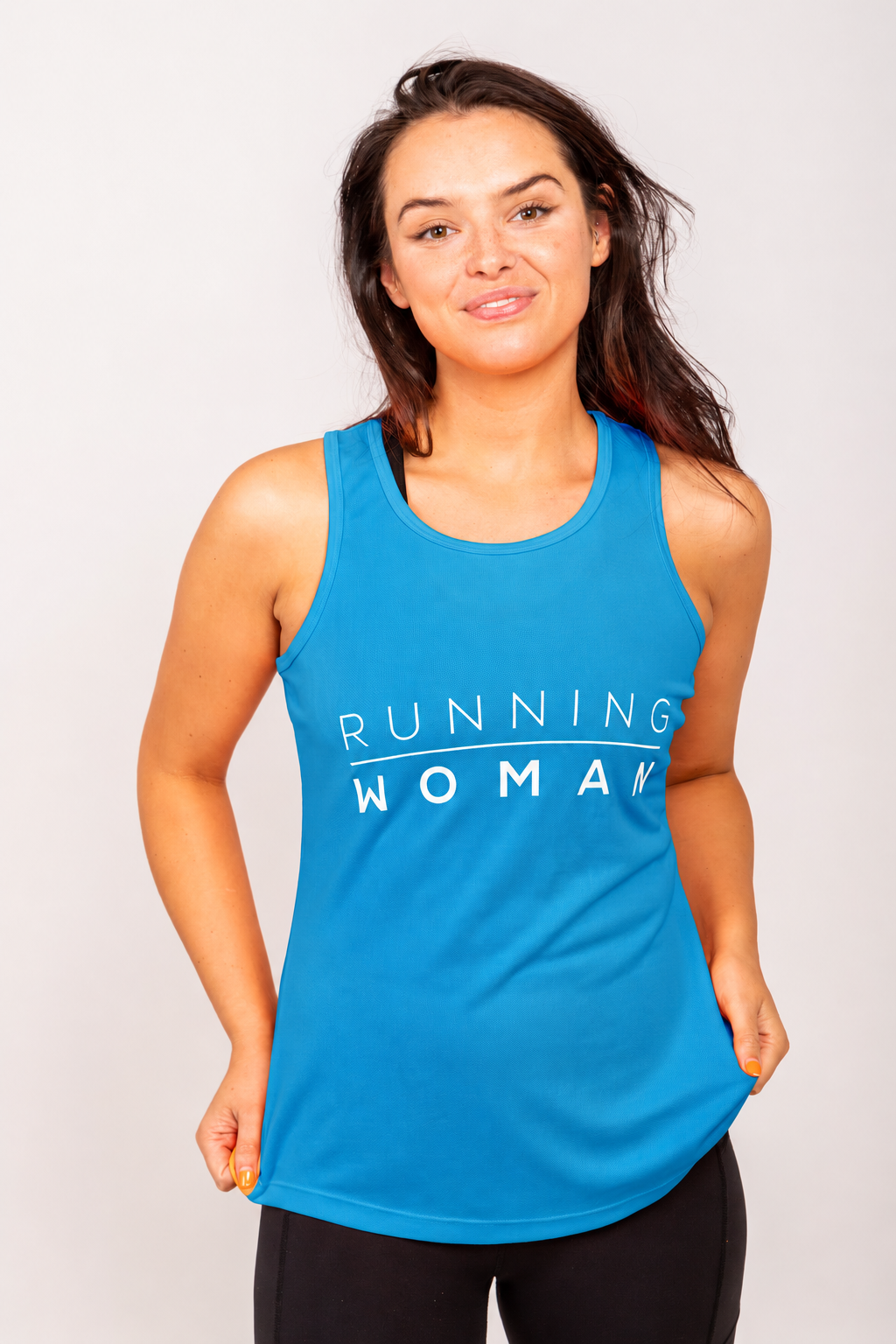 Sapphire blue Running Woman running vest on a model holding the hem