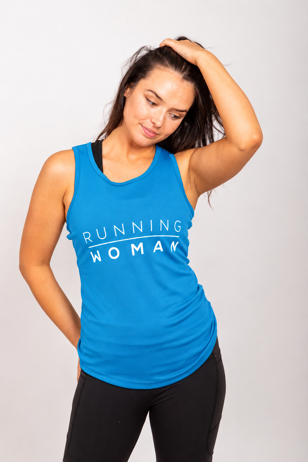 Sapphire blue Running Woman running vest on a model looking down with one hand on her head