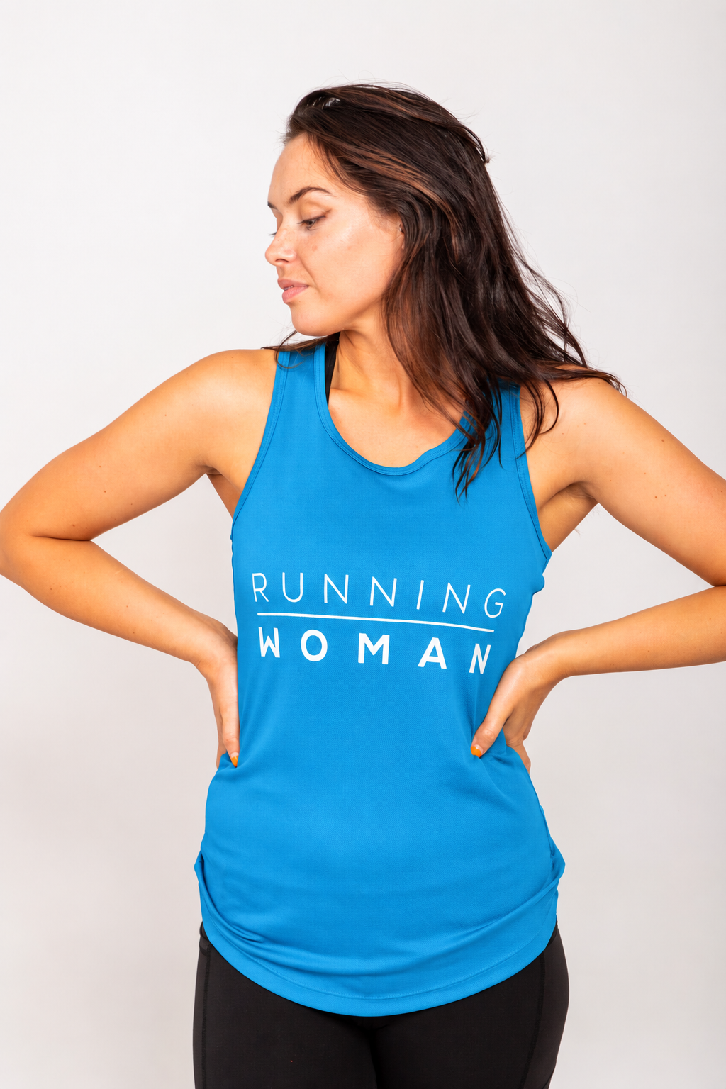 Sapphire blue Running Woman running vest on a model looking to the side with both hands on her hips